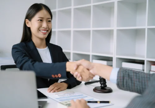 lawyer shaking hands with client after contract agreement